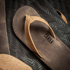 Original Wanderer sandal on a sheet of Vibram rubber with leather and cork on the side showing the quality materials from which it is crafted.